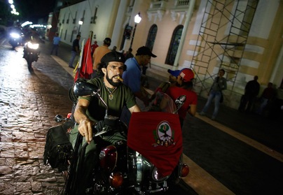 Caracas, Venezuela: a Che Guevara lookalike rides his motorcycle at a gathering in support of President-elect Nicolás Maduro
