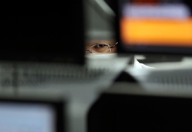 Tokyo, Japan: An employee at a foreign exchange trading company looks at monitors